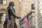 Wall street in manhattan finance district and washington statue in the foreground