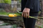 mourning-man-bringing-tulips-cemetery
