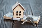 small-toy-house-with-keys-bundle-banknotes-brown-wooden-boards