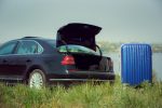 view-modern-black-car-blue-suitcase-river-s-side-sunny-day