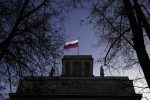 A Russian flag waves on top of the Russian Embassy