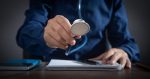 Caucasian man holding stethoscope at office