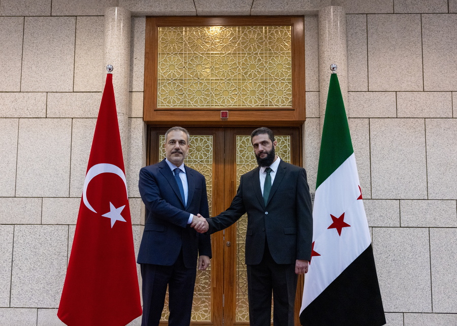Turkish Foreign Minister Hakan Fidan and Syria's rebel leader Ahmed al-Sharaa, also known as Abu Mohammed al-Jolani