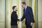 Volodymyr Zelensky shaking hands with Friedrich Merz
