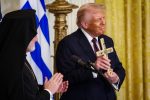 Archbishop Elpidophoros of the Greek Orthodox Archdiocese of America presents US President Donald Trump a holy cross