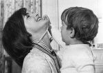 This 1962 file photo shows John F. Kennedy, Jr. playing with his mother's necklace at the White House.