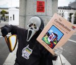 African man wears a 'Scream' mask a