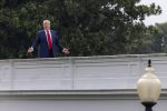 US President Donald J. Trump responds to a question from the news media as he tours the roof at the White House in Washington