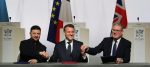Ukraine's President Volodymyr Zelensky, France's President Emmanuel Macron and Britain's Prime Minister Keir Starmer shake hands