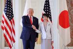 President Donald Trump (L) shakes hands with Japan's Prime Minister Sanae Takaichi