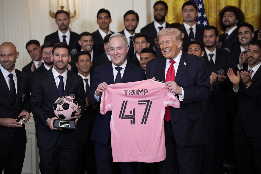 US President Donald Trump (R) poses for photographs with the Major League Soccer champions Inter Miami CF