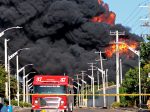 Firefighters work to put out a fire in a fuel tank