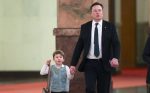 Tesla CEO Elon Musk (C) and his son X Æ A-12