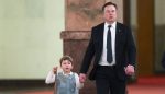 Tesla CEO Elon Musk (C) and his son X Æ A-12