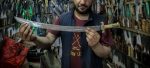 A vendor displays a knife ahead of Eid al-Adha in Kabul, Afghanistan,