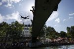 Youths jump from a bridge to cool off in the Canal Saint-Martin, in Paris,