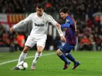 Barcelona's Lionel Messi (R) in action against Real Madrid's Cristiano Ronaldo