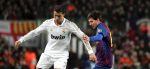 Barcelona's Lionel Messi (R) in action against Real Madrid's Cristiano Ronaldo