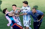 Gavi (L) of Spain clashes with Nahuel Molina (C) and Leandro Paredes