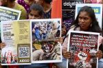 Students and members of The All India Democratic Youth Organization (AIDYO) hold placards during a protest against