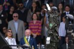 A robot dressed in the uniform of the Brazilian Armed Forces salutes President Luiz Inacio Lula da Silva (2-L) and First Lady Rosangela Lula da Silva