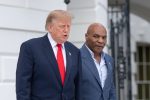 US President Donald Trump walks with Mike Tyson